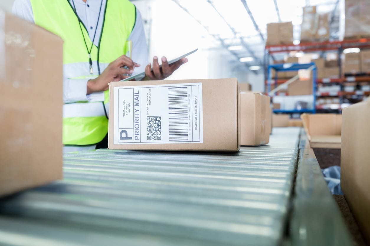 Man looking at boxes in warehouse