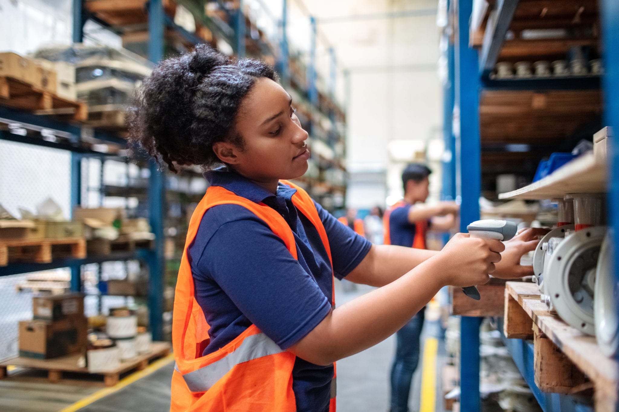 Warehouse worker checking cargo on shelves with scanner Warehouse Worker