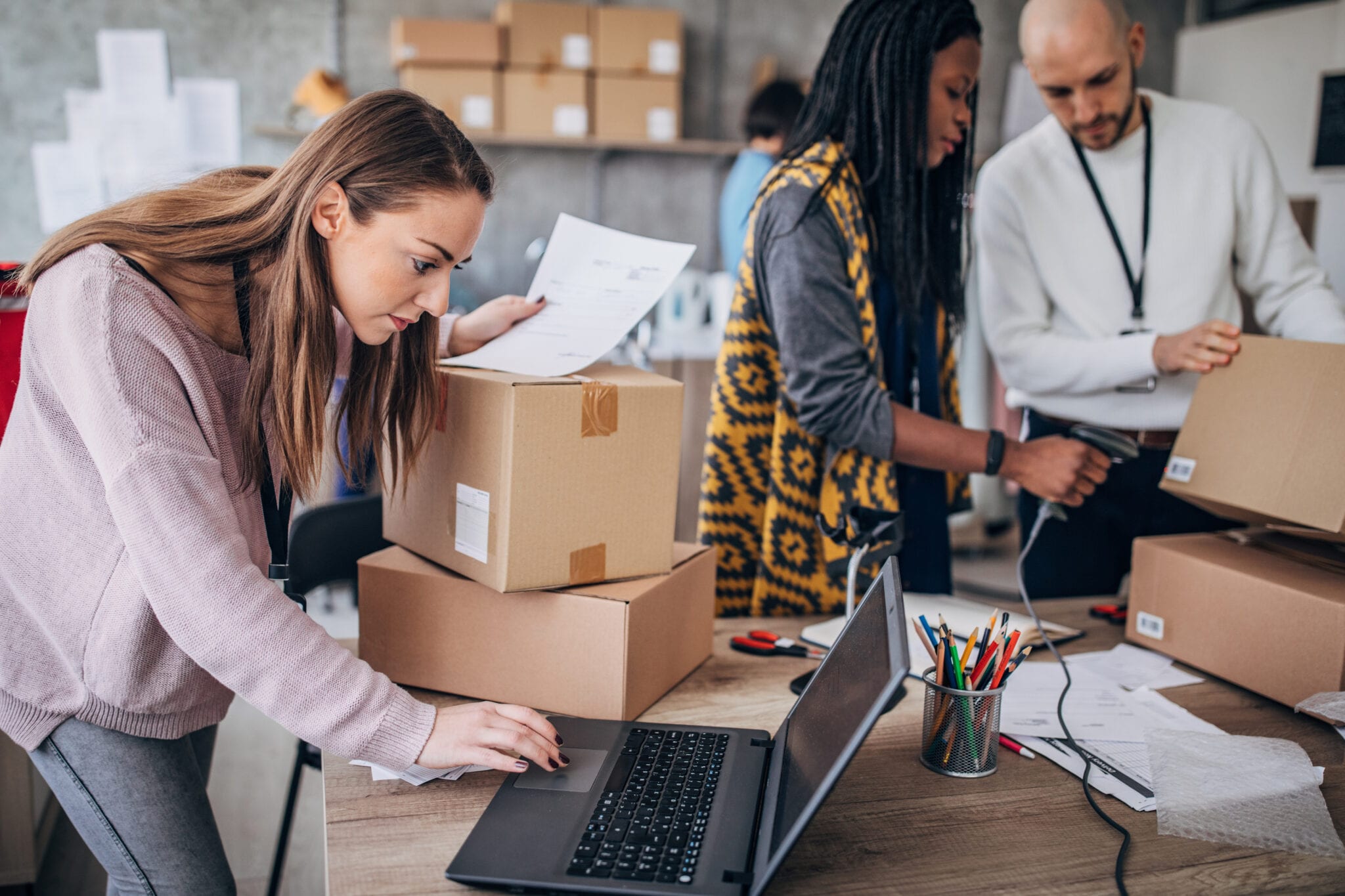 Woman using laptop for arranging customers orders for drop shipping